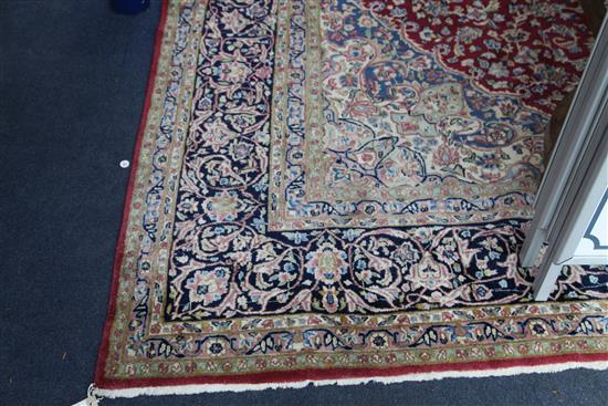 An Isfahan red and ivory ground carpet, 12ft 10in by 9ft 10in.